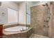 Luxurious bathroom showcases a soaking tub and glass-enclosed shower at 11808 E Clinton St, Scottsdale, AZ 85259