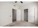 Bright bedroom offers a carpeted floor, a ceiling fan, and double closet doors at 11808 E Clinton St, Scottsdale, AZ 85259