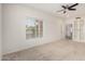 Light-filled bedroom boasts a ceiling fan and a window overlooking the neighborhood at 11808 E Clinton St, Scottsdale, AZ 85259