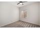 Bedroom features neutral carpet, a ceiling fan, and a window with blinds at 11808 E Clinton St, Scottsdale, AZ 85259
