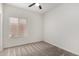 Cozy bedroom features neutral carpet, ceiling fan, and a window with blinds at 11808 E Clinton St, Scottsdale, AZ 85259