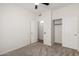 Bright bedroom offers a carpeted floor, a ceiling fan, and double closet doors at 11808 E Clinton St, Scottsdale, AZ 85259