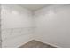 Walk-in closet with white wire shelving and laminate flooring at 11808 E Clinton St, Scottsdale, AZ 85259