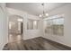 Dining room with gray wood floors, natural light, and an arched entrance to the foyer at 11808 E Clinton St, Scottsdale, AZ 85259