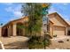Corner lot featuring desert landscaping and a one-story house with a tan stucco facade at 11808 E Clinton St, Scottsdale, AZ 85259