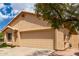 Close up view of the front of a one-story home with a two-car garage and beige stucco at 11808 E Clinton St, Scottsdale, AZ 85259