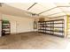 Spacious garage with concrete floor, shelving, and water heater at 11808 E Clinton St, Scottsdale, AZ 85259