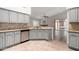 Open kitchen with gray cabinets, tile backsplash, granite countertops, and stainless steel appliances at 11808 E Clinton St, Scottsdale, AZ 85259