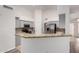 Open kitchen with gray cabinets, granite countertops, and stainless steel appliances at 11808 E Clinton St, Scottsdale, AZ 85259