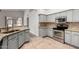 Kitchen featuring granite countertops, stainless steel appliances, and gray cabinets at 11808 E Clinton St, Scottsdale, AZ 85259