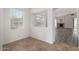 Entryway with tile floors leading to a large living room with a fireplace and wood floors at 11808 E Clinton St, Scottsdale, AZ 85259