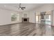 Bright living room features a stone fireplace, modern floors, and sliding doors to the outdoor pool area at 11808 E Clinton St, Scottsdale, AZ 85259