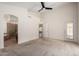 Large main bedroom offers a ceiling fan and access to the bathroom and backyard at 11808 E Clinton St, Scottsdale, AZ 85259