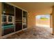 Covered patio with stone tile flooring and view of the pool and backyard at 11808 E Clinton St, Scottsdale, AZ 85259
