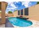 Tranquil backyard pool area with tile surround and decorative wall, offering a private retreat at 11808 E Clinton St, Scottsdale, AZ 85259