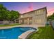 Backyard with an inviting swimming pool, covered patio, and lush green lawn at 1253 E Ivanhoe Ct, Gilbert, AZ 85295