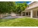 Spacious backyard featuring a sports court, covered patio, and mature landscaping; perfect for outdoor living at 1253 E Ivanhoe Ct, Gilbert, AZ 85295