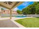 Backyard featuring a sparkling pool, green lawn, and covered patio; ideal for outdoor enjoyment at 1253 E Ivanhoe Ct, Gilbert, AZ 85295