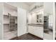 Bathroom featuring vanity with double sinks and an attached closet at 1253 E Ivanhoe Ct, Gilbert, AZ 85295
