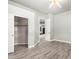 Spacious bedroom featuring wood floors, a closet, and a doorway to another room at 1253 E Ivanhoe Ct, Gilbert, AZ 85295