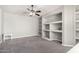 Neutral bedroom features built-in shelving and ceiling fan at 1253 E Ivanhoe Ct, Gilbert, AZ 85295