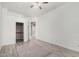 Bedroom with wood-look flooring, ceiling fan, closet, entry to en-suite bath and neutral paint at 1253 E Ivanhoe Ct, Gilbert, AZ 85295