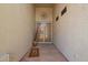 Welcoming entryway featuring neutral walls, decorative metal art, and a secure screen door at 1253 E Ivanhoe Ct, Gilbert, AZ 85295