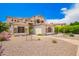 Two-story home featuring a clay tile roof, stucco siding, and desert landscaping at 1253 E Ivanhoe Ct, Gilbert, AZ 85295