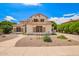 Two-story home featuring a clay tile roof, stone accents, and low-maintenance landscaping at 1253 E Ivanhoe Ct, Gilbert, AZ 85295