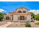 Beautiful two-story home showcasing a clay tile roof, stone accents, and manicured landscaping at 1253 E Ivanhoe Ct, Gilbert, AZ 85295