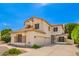 Two-story home featuring a three-car garage, clay tile roof, and desert landscaping at 1253 E Ivanhoe Ct, Gilbert, AZ 85295