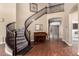 Spacious foyer featuring a staircase with decorative railing, hardwood floors, and open floorplan at 1253 E Ivanhoe Ct, Gilbert, AZ 85295