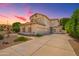 Spacious home with a three-car garage, desert landscaping, and paver walkway at 1253 E Ivanhoe Ct, Gilbert, AZ 85295