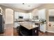 Bright and open kitchen featuring white cabinets, granite countertops, and an island with bar seating at 1253 E Ivanhoe Ct, Gilbert, AZ 85295