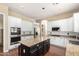 Kitchen featuring white cabinets, granite countertops, stainless appliances, and island at 1253 E Ivanhoe Ct, Gilbert, AZ 85295