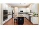 Eat-in kitchen with white cabinets, granite countertops, stainless appliances, and island at 1253 E Ivanhoe Ct, Gilbert, AZ 85295
