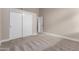 This bedroom features plush carpeting, a neutral color scheme, and a spacious closet for ample storage at 1333 E Bermuda Bay Ct, Gilbert, AZ 85234
