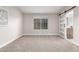 Neutral bedroom with a large window and a decorative sliding barn door at 1333 E Bermuda Bay Ct, Gilbert, AZ 85234