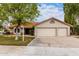 Charming single-story home with a well-manicured front yard, three-car garage, and terracotta roof tiles at 1333 E Bermuda Bay Ct, Gilbert, AZ 85234