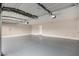 Spacious garage with an epoxy floor, overhead lighting and a single door to the home's interior at 1333 E Bermuda Bay Ct, Gilbert, AZ 85234