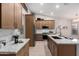 Bright kitchen featuring wood cabinets, stainless steel appliances, and a spacious island with white marble countertops at 1333 E Bermuda Bay Ct, Gilbert, AZ 85234