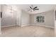 Open-concept living room with vaulted ceiling, neutral paint colors, wood-look tile floors, and a large window at 1333 E Bermuda Bay Ct, Gilbert, AZ 85234