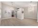 Spacious living space showcasing the open layout, modern light fixtures, and stylish sliding barn door feature at 1333 E Bermuda Bay Ct, Gilbert, AZ 85234