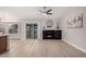Open living area with a fireplace, tile floors, and sliding glass doors leading to outdoor space at 1333 E Bermuda Bay Ct, Gilbert, AZ 85234