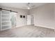 Spacious bedroom with a ceiling fan, multiple windows, and a bathroom entrance at 1333 E Bermuda Bay Ct, Gilbert, AZ 85234
