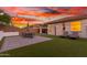 Private backyard featuring a patio, lounge chairs and well-maintained green space perfect for entertaining at 13720 W Amberwing St, Peoria, AZ 85383