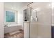 Bright bathroom featuring soaking tub and a glass enclosed shower at 13720 W Amberwing St, Peoria, AZ 85383