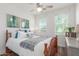 Charming bedroom featuring a comfy queen bed, ceiling fan, and two windows with natural light at 13720 W Amberwing St, Peoria, AZ 85383