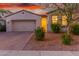 Charming single-story home featuring a two-car garage and attractive desert landscaping at 13720 W Amberwing St, Peoria, AZ 85383