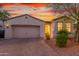 Charming single-story home featuring a two-car garage and attractive desert landscaping at 13720 W Amberwing St, Peoria, AZ 85383